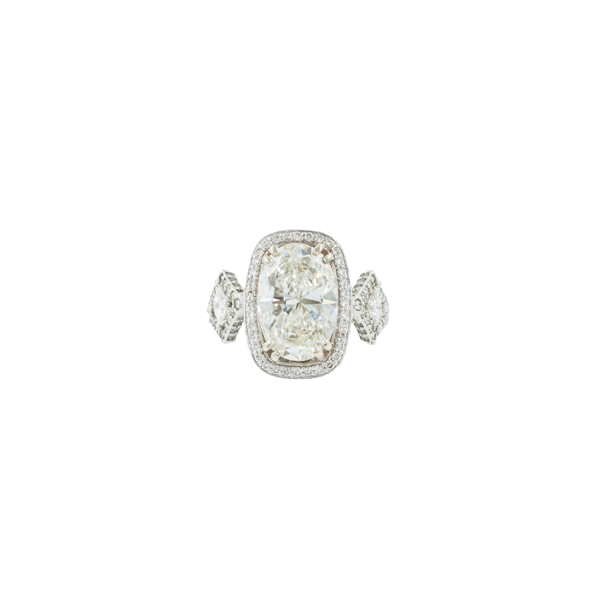 Diamond ring with a large central gemstone and smaller stones on a white background