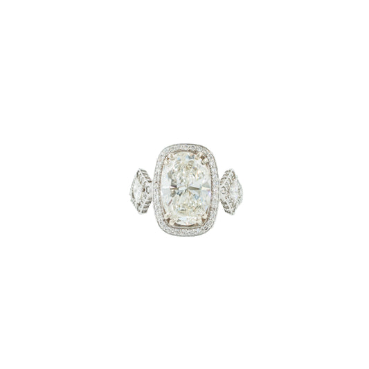Diamond ring with a large central gemstone and smaller stones on a white background