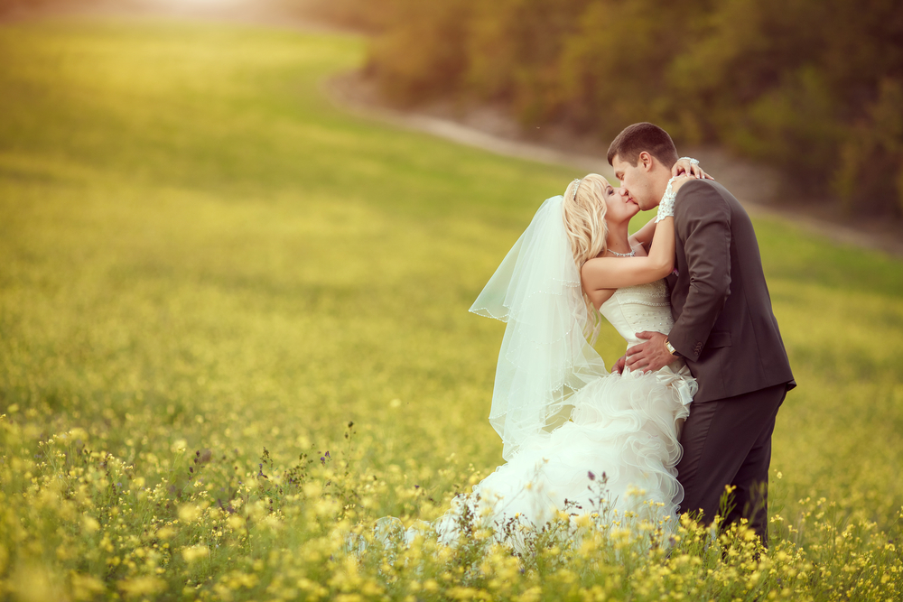 spring wedding couple kissing field flowers